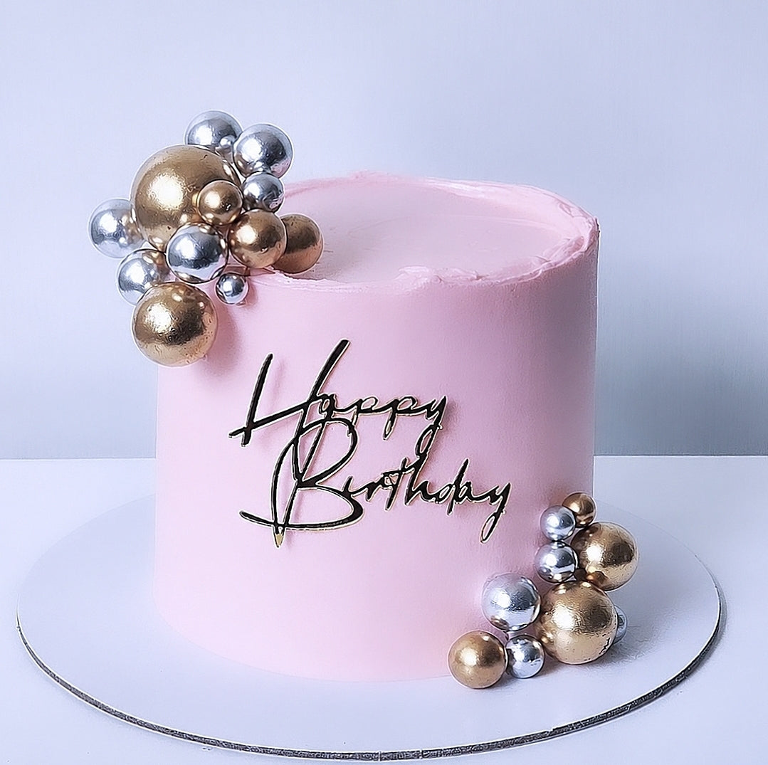 Pink birthday cake with gold and silver decorations and 'Happy Birthday' text , sydney 
