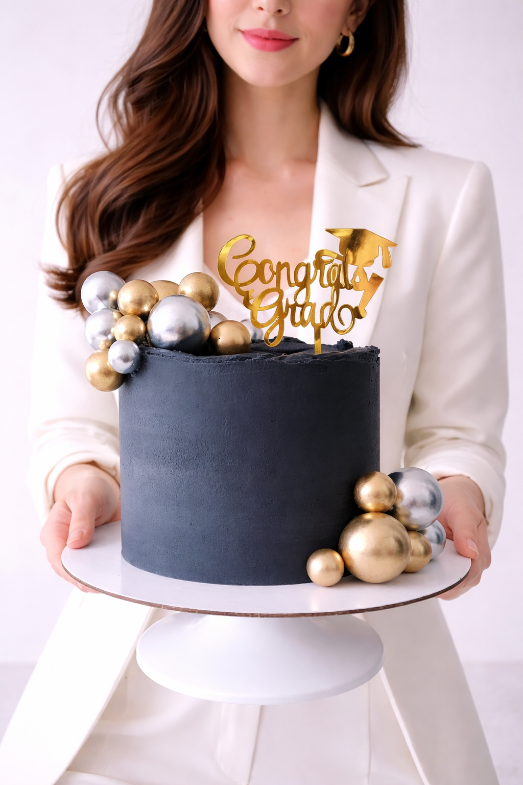 Black cake with gold and silver decorations and 'Congrats Grad' topper. Sydney 