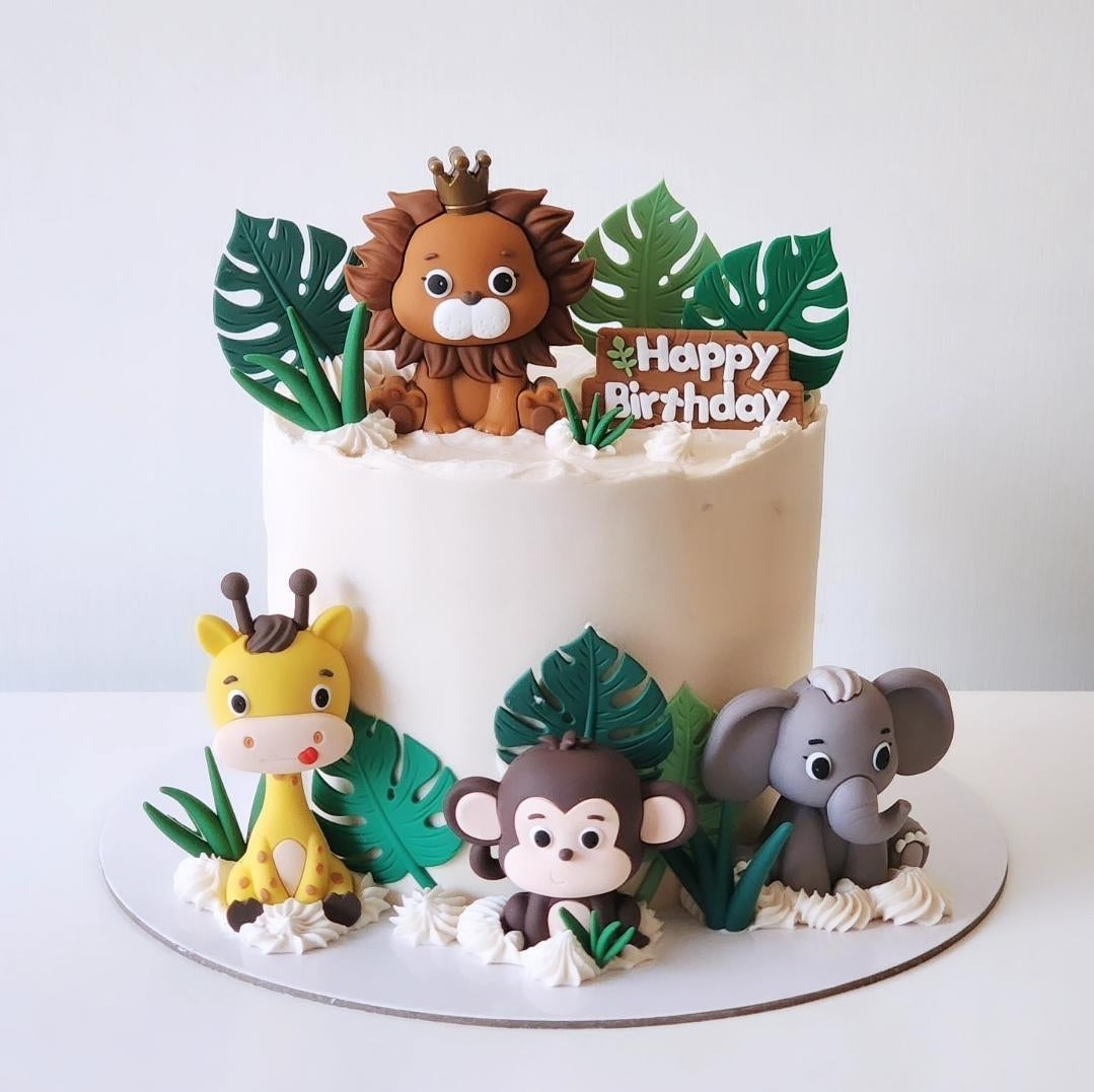 Children's jungke safari birthday cake with animal toppers on a white background sydney