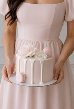 Pink cake with white drip flower and macaron sydney