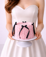  pink ruffle cake with black ribbons . Sydney