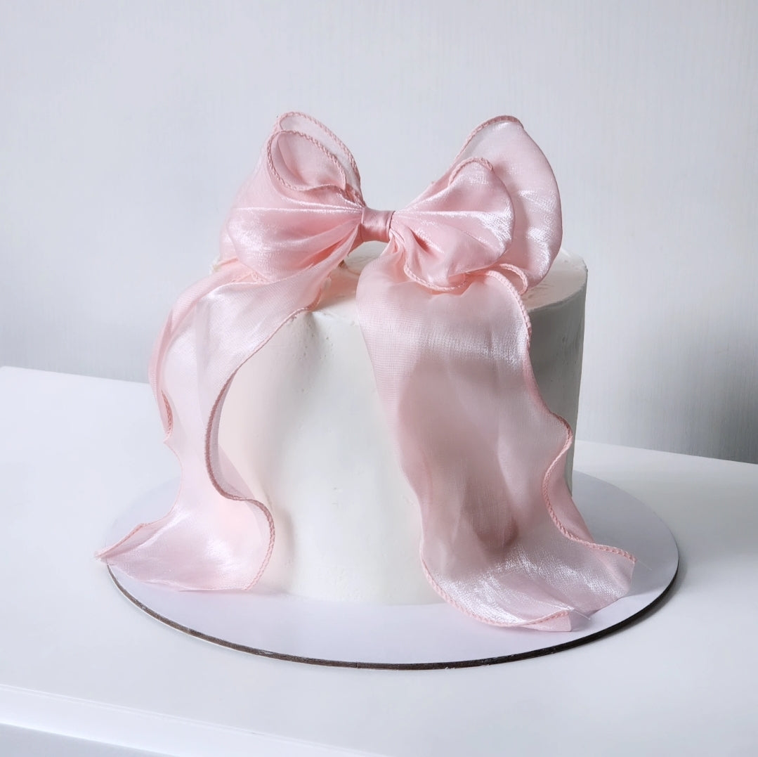White cake with a large pink satin bow  Sydney