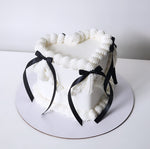 White heart cake with black ribbons sydney