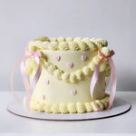 Yellow cake with decorative pink ribbons and pink hearts sydney 